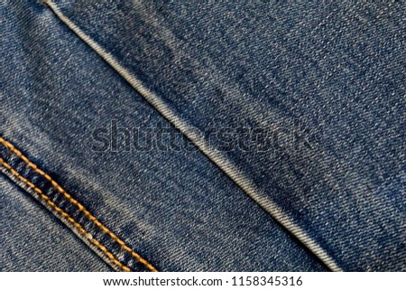 Blue jeans texture background. Ripped fabric with bleached scratch trace. Royalty-Free Stock Photo #1158345316