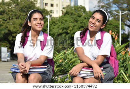 Stitched Photo of Happy Teen Female Student Posing As Twin Sisters