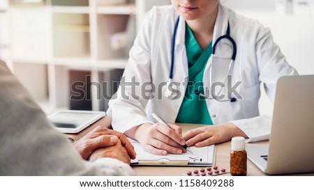 Doctor giving prescription to patient Royalty-Free Stock Photo #1158409288