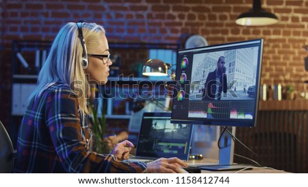Side view of casual woman in headphones working on computer and editing video with color correction