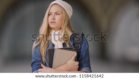Casual white female college student looking around while on campus Royalty-Free Stock Photo #1158421642