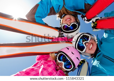 Skiing, winter fun - skiers enjoying ski holidays Royalty-Free Stock Photo #115843321