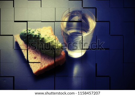 alcoholism. social problems loneliness. glass of vodka bread and pickle on a dark background. a picture falling to pieces. double vision strong intoxication
