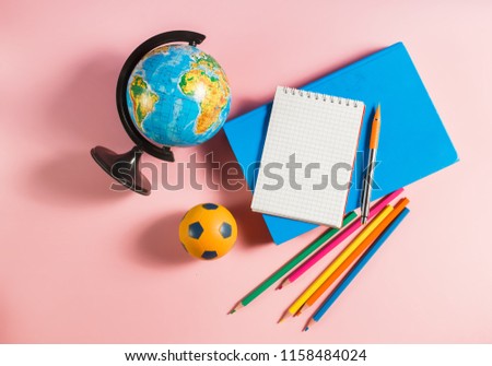 Back to school concept. Globe with school supplies.