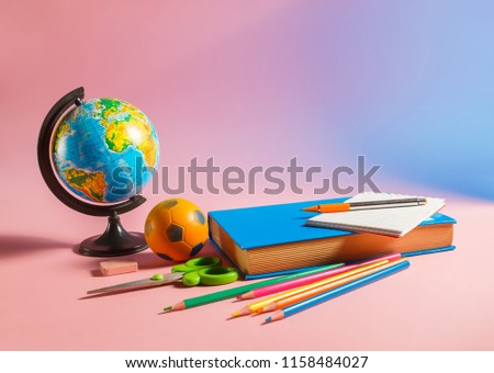 Back to school concept. Globe with school supplies.