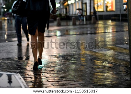 close up people walking in the city street during the heavy rain