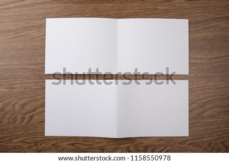 Mockup of white booklet on wooden background