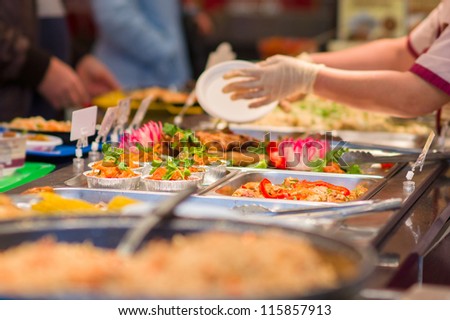 Salads and other dishes with vegetables and meat on table in restaurant