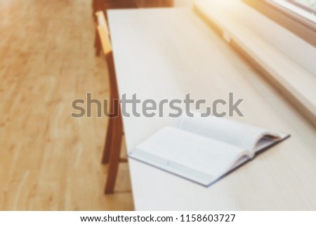 Blur image of picture library background. Library resources, including vast knowledge. and sun light. Book in library with open textbook. Old university shelves. culture concept.