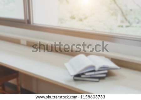 Blur image of picture library background. Library resources, including vast knowledge. and sun light. Book in library with open textbook. Old university shelves. culture concept.