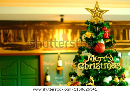 Luxury interior of restaurant with decorated Christmas tree and gifts.