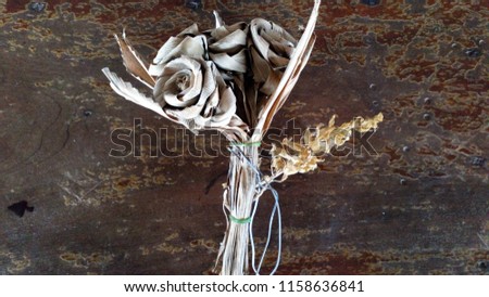 Dried flowers placed on wooden table.