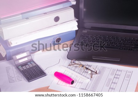 Business finance document with notebook. Mokuru toy on office table