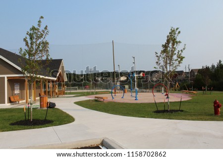 Newly constructed children's splash pad in playground park in summer.