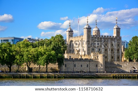 View of the Tower of London, a castle and a former prison in London, England, from the River Thames. The Tower of London, today a museum, is a fortified complex that includes multiple buildings Royalty-Free Stock Photo #1158710632