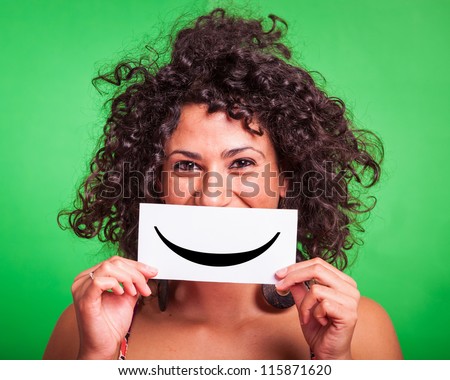 Young Woman with Smiley Emoticon on Green Background Royalty-Free Stock Photo #115871620