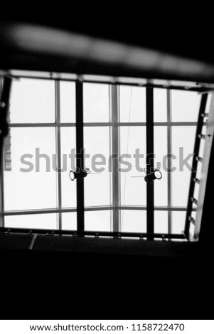 photo of a window, picture of a window on the roof, view from below. Abstraction window
