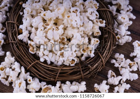 Fresh cooked Salty popcorn on wooden background
