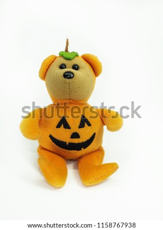 Teddy bear wearing pumpkin Halloween costume White background