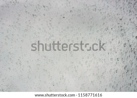 Water droplets on the glass with a colored background. Drops of water.