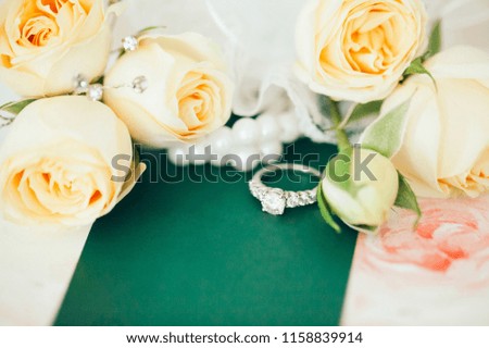 Wedding ring and flower bouquet arrangement.