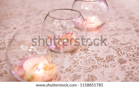 Wedding table decoration. Tea candles with flower arrangements.