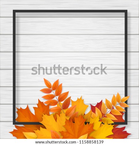 Black frame with autumn fallen leaves on white wooden background. Background for seasonal sale offer or design element banner.