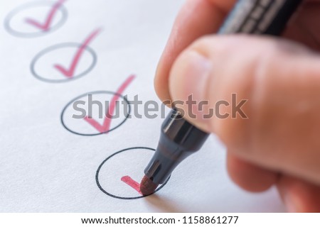 Checking completed tasks on a list Royalty-Free Stock Photo #1158861277