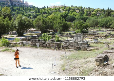 Tourist female takes picture of the Ancient Agora of Athens, Greece