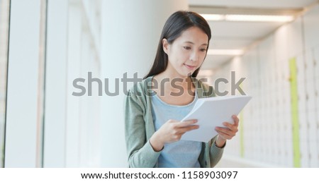 Woman reading on note at school