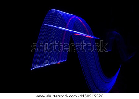 Colorful Light Painting Photography With Parallel Lines, Waves And Curves Against A Black Background