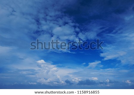 Perspective view of romantic navy blue sky with white grey clouds. Beautiful sky. High resolution artistic skyline background image