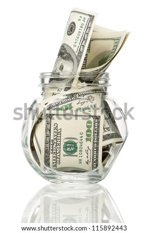 Many dollars in a glass jar isolated on white background