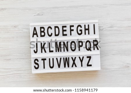 Back to school concept. Letters from A to Z. English alphabet on modern board over white wooden background, top view. From above, flat lay, overhead.