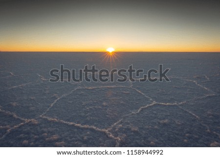 Sunrise on the world famous Uyuni Salt Flats in Bolivia looking over 11,000 square kilometers of pure salt