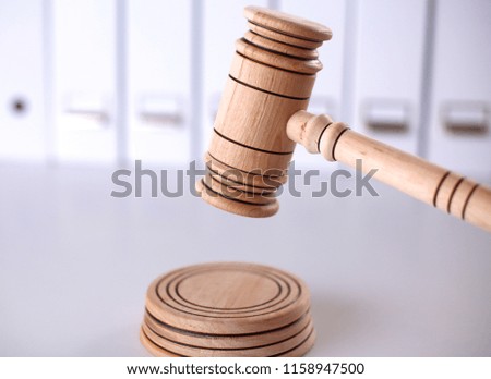 A wooden judge gavel and soundboard isolated on white backgroun
