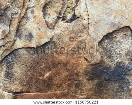 Old stone grunge texture background of cracked sandstone rock with worn weathered surface, rustic construction material