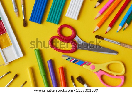 School supplies on a yellow background.