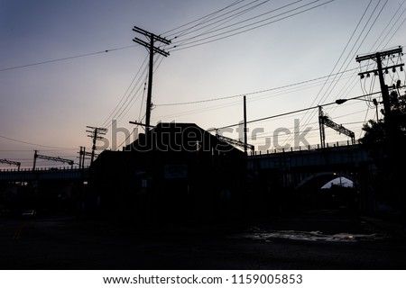 Silhouette of telephone wires and buildings on clear day