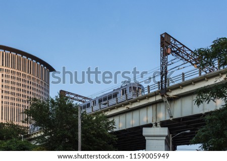 Train passing overhead in urban area with clear sky