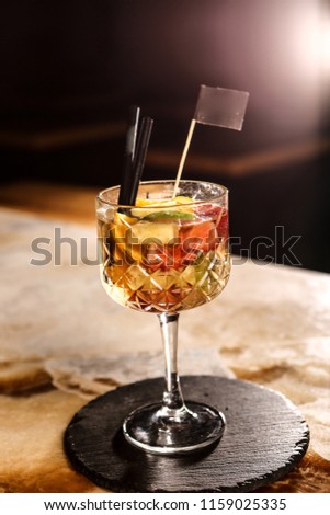 Sangria with fruit, ice and mint in glass.
