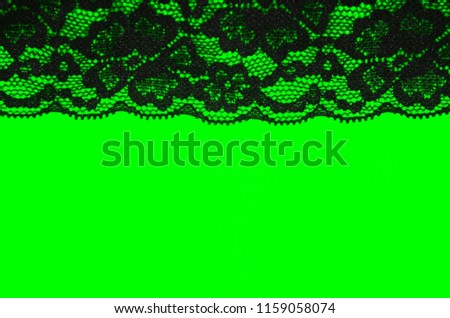 Black lacy embroidery ribbon frame neon green background