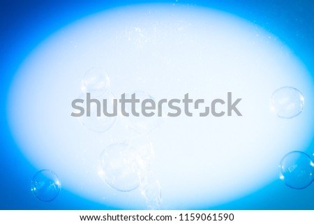 A digitally enhanced bubble design with a dark blue vignette style border overlay.