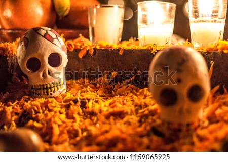 Day of the dead Skull in a cemetery in Janitzio Mexico. Altar with cempasuchil flowers and candles.