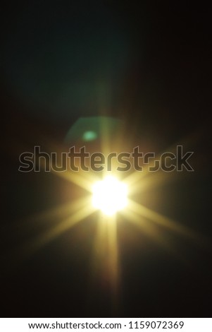 A glowing star burst lens flare overlay effect.