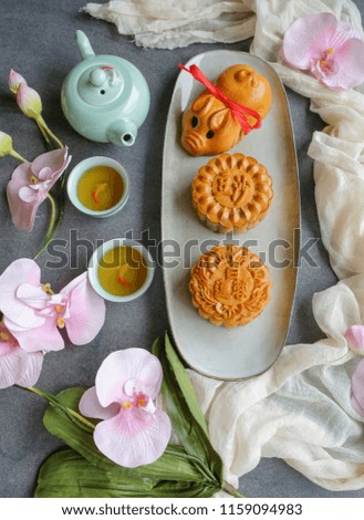 Chinese pastries eaten during the Mid-Autumn Festival / Traditional Chinese Mooncake /  Typical mooncakes are round but some are made into animal shaped. Chinese characters are red bean, lotus paste