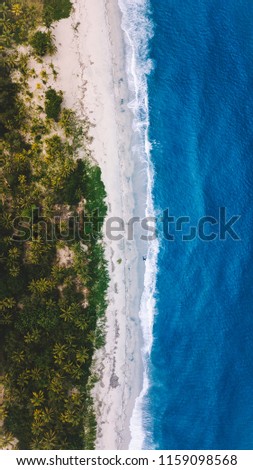 Aerial of a stunning blue and white sand beach on the Northern Coast of Colombia.