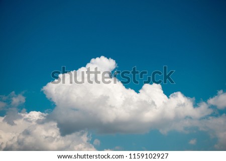 White color clouds cover the blue sky in the daytime