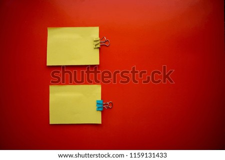 Сolorful blank sticky note or empty post notes with office clamps on red background for reminder remember on working or appointment with customer, coworker, supplier, teamwork and etc.