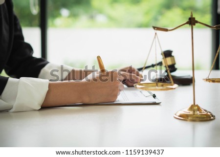 Professional female lawyers working at the law firms. Judge gavel with scales of justice on the table. Concept of law. Royalty-Free Stock Photo #1159139437